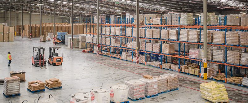 Large warehouse interior with forklift and pallet racking